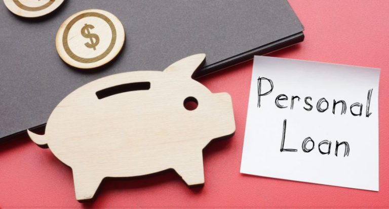 An image of a wooden puggy bank on a desk with a note that says "personal loan"