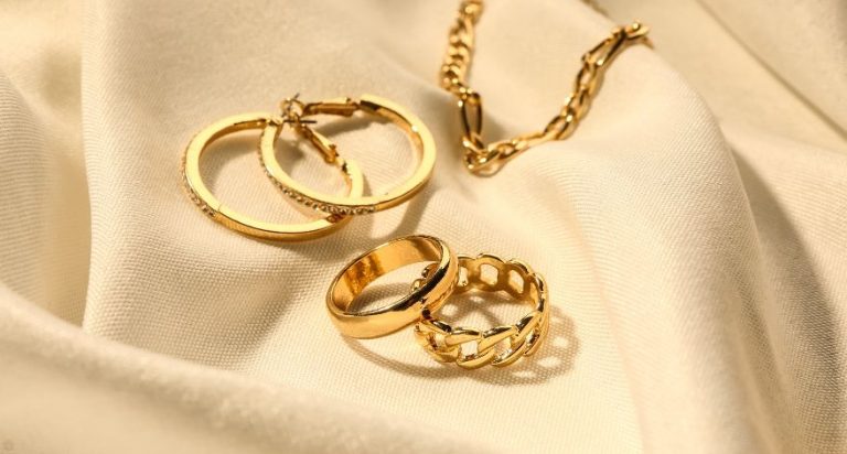 Gold earrings, rings, and a gold necklace.