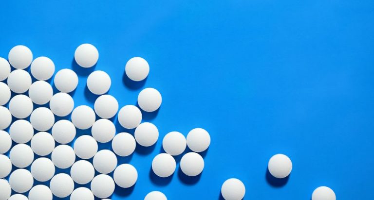 White circular pills on a blue background.