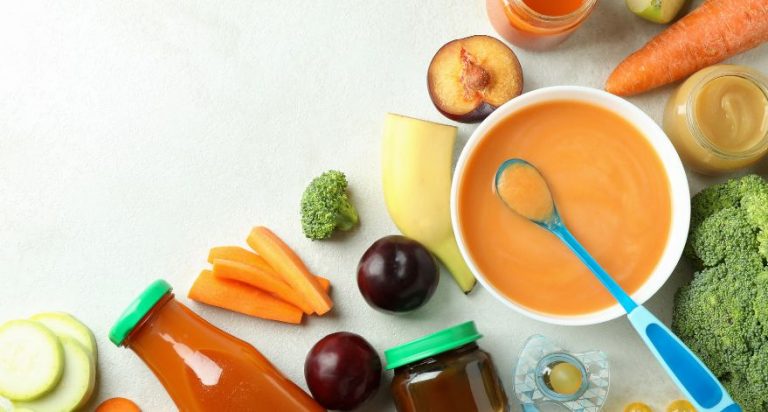 A variety of different baby foods, including blended puree, formula, and fresh produce.